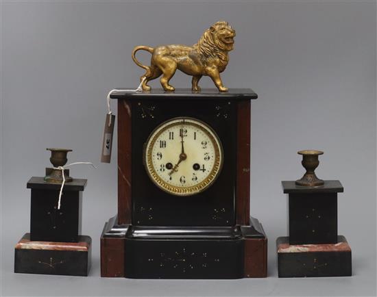 A Victorian rouge and black marble clock garniture, the clock of architectural form